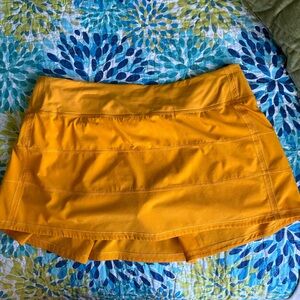 Pace Rival Mid-Rise Skirt in the color clementine size 10.